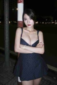 KL Escort Girl Woman in polka dot dress posing outdoors at night Malaysia Sex Call Girl