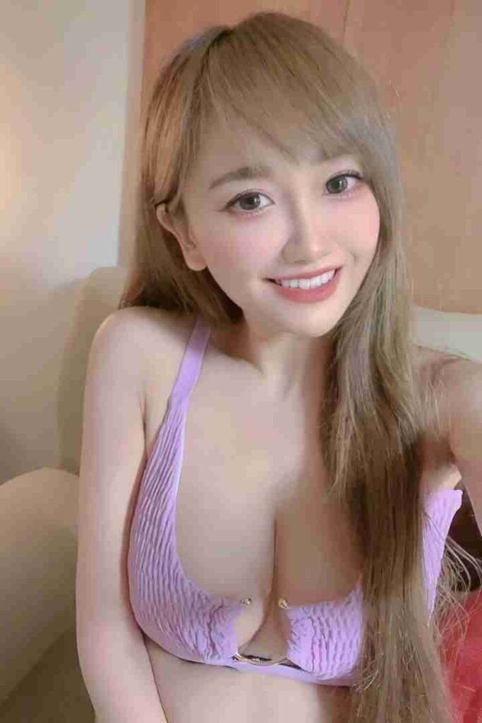 KL Escort Girl Smiling woman with blonde hair wearing a purple top Malaysia Sex Call Girl