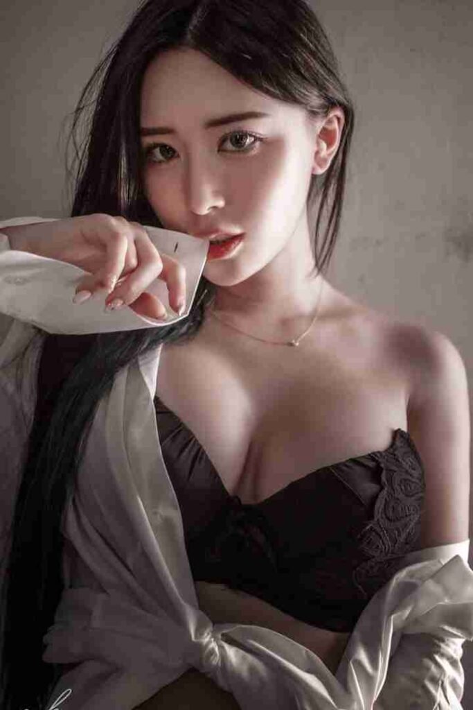 KL Escort Girl Woman in black bra and white shirt, sultry pose. Malaysia Sex Call Girl