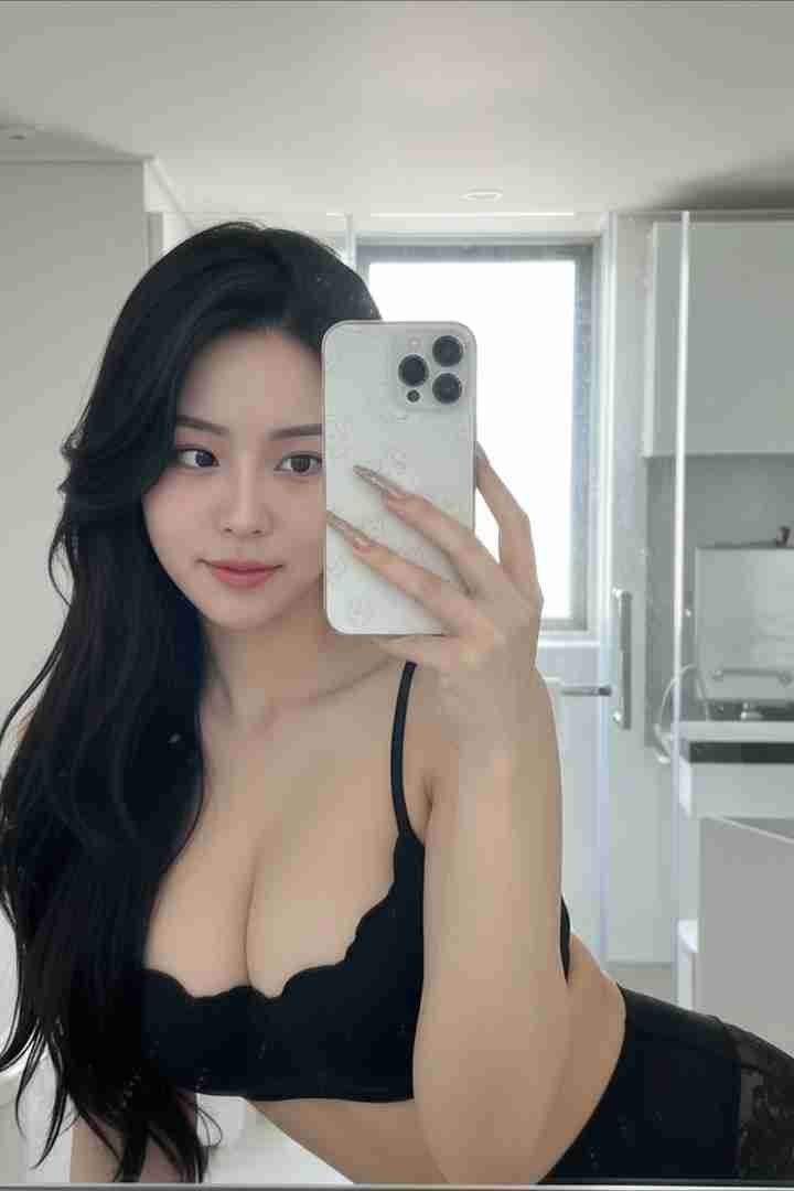 KL Escort Girl Woman in black lingerie takes a selfie in front of a mirror. Malaysia Sex Call Girl