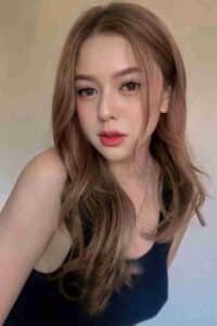 KL Escort Girl Young woman with long brown hair posing indoors Malaysia Sex Call Girl
