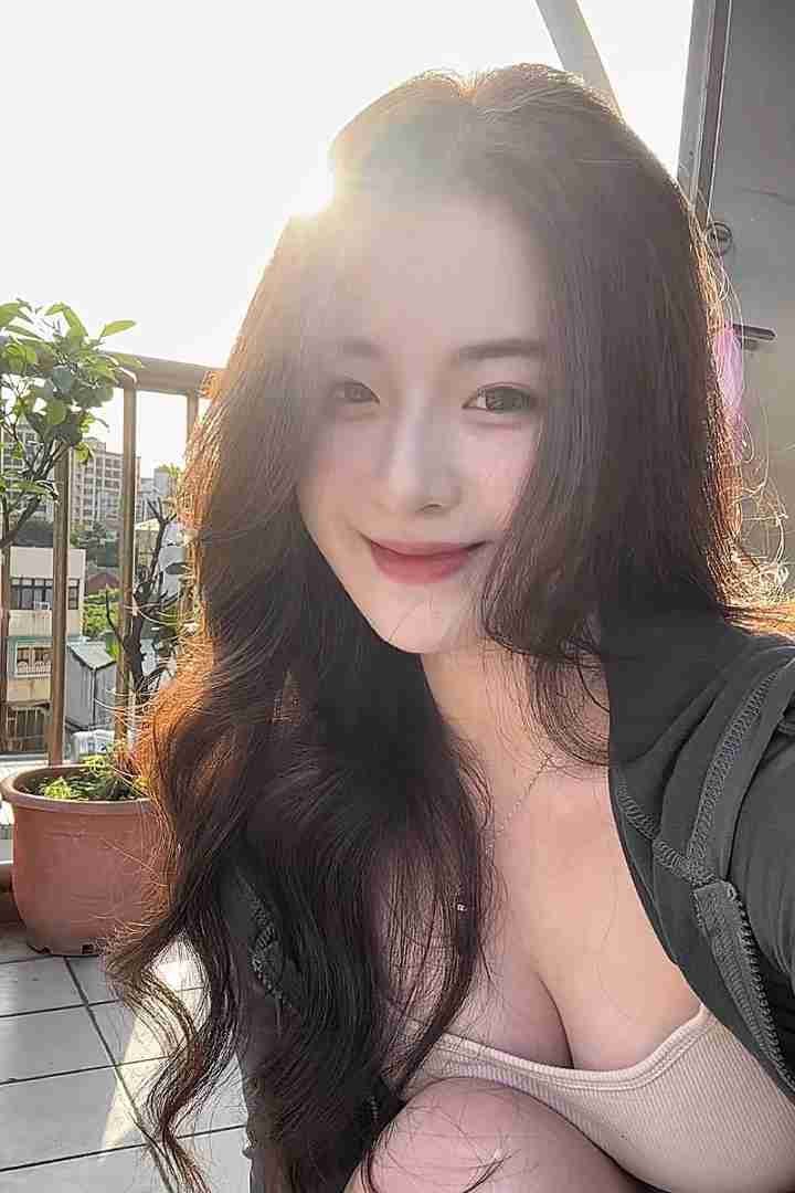 KL Escort Girl Portrait of a beautiful woman with long wavy hair smiling in sunlight. Malaysia Sex Call Girl