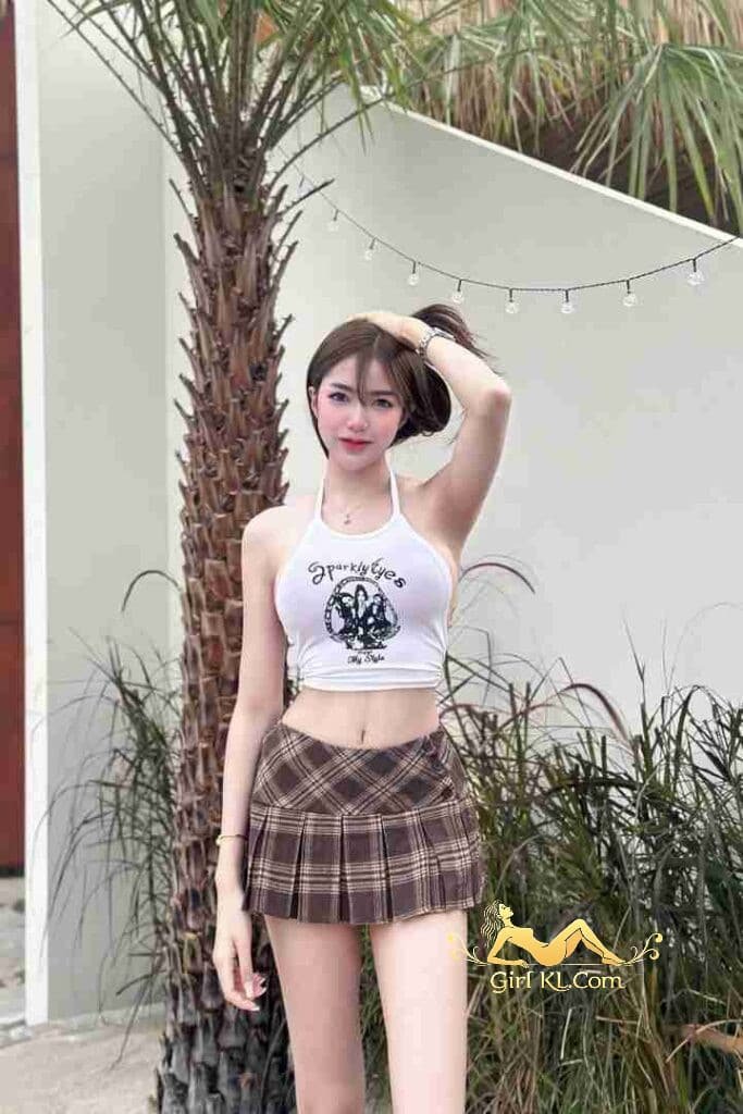 Arisa, Thai model in halter top and plaid skirt posing outdoors. "Sparkly Eyes" text on top.