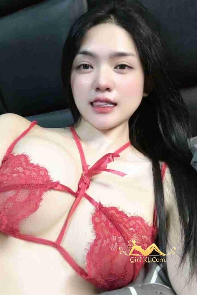 Attractive Asian woman in red lace lingerie, posing indoors. Kiera, Thai Grace.