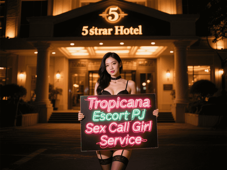 Asian woman holding Tropicana Escort PJ sign in front of a hotel at night.