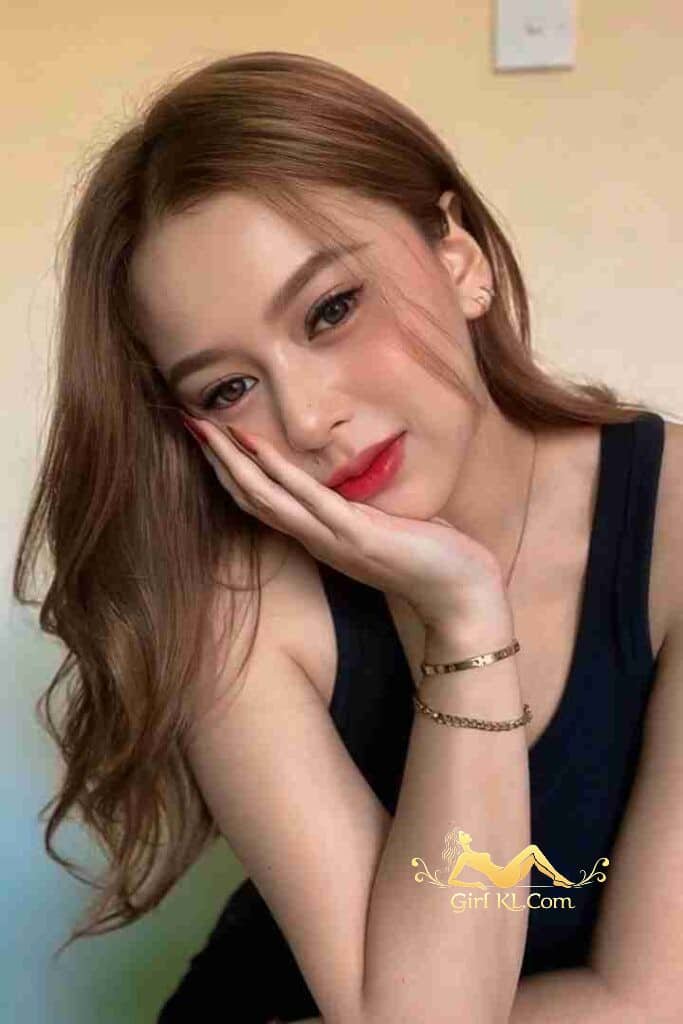 Attractive Malay girl, Safiyyah, posing with hand on cheek, red lipstick