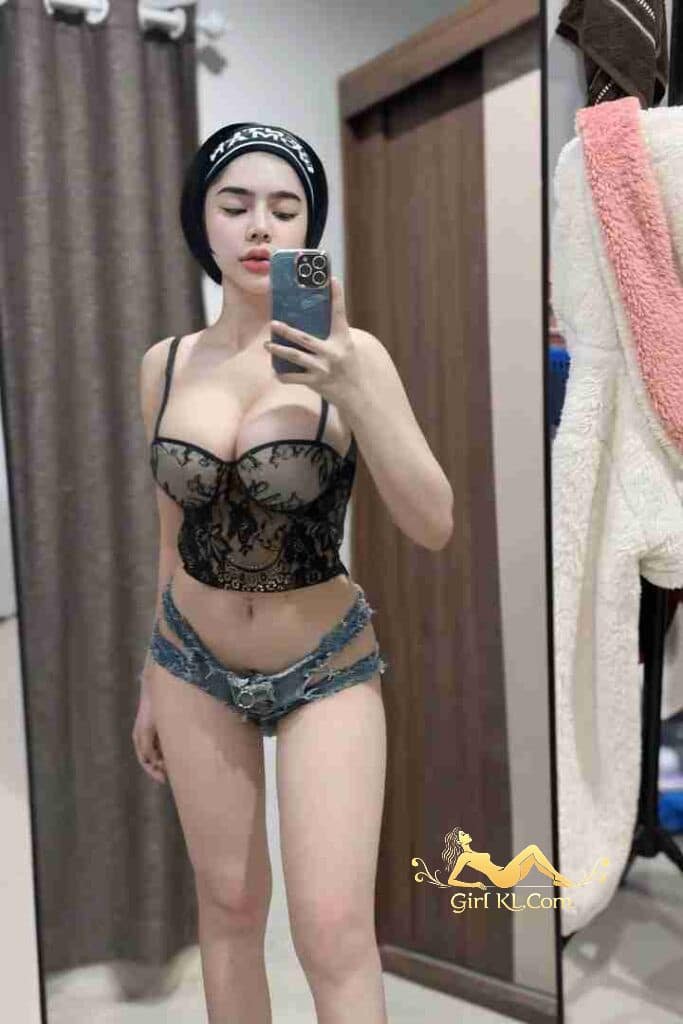Thai babe in lingerie taking mirror selfie. C cup escort in KL.