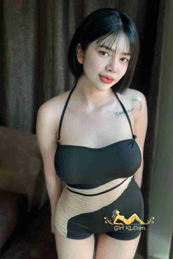 Thai babe in black and beige swimsuit with tattoo. KL escort. Risa ready for fun.