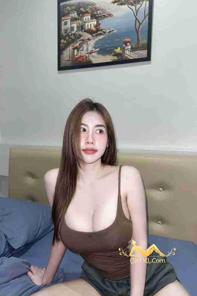 Attractive Thai woman with C cup curves in brown top. Nori, KL Escort.