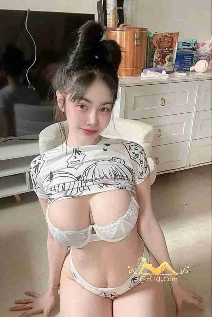 Gina: Thai woman with D cup, in bra and panties, sitting indoors. KL Escort Incall/Outcall Services.