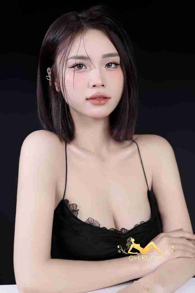 Stunning Vietnamese woman, Celina, with dark hair in black dress. C cup beauty, Kuala Lumpur escort.
