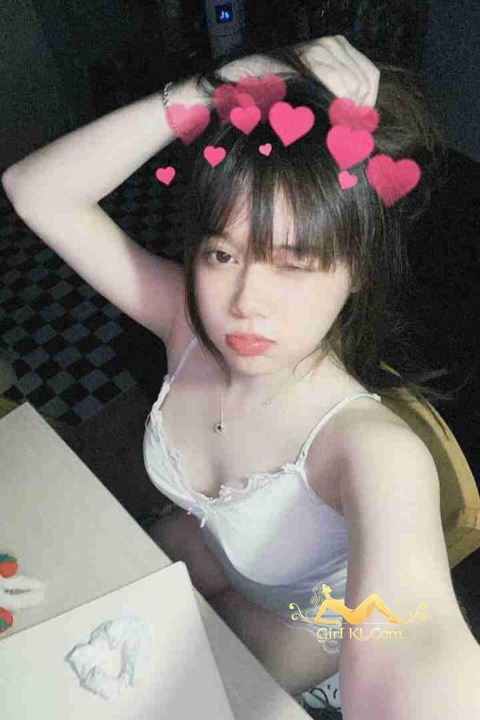 Young Vietnamese woman with bangs and white top, heart filter. Mia, KL Escort.