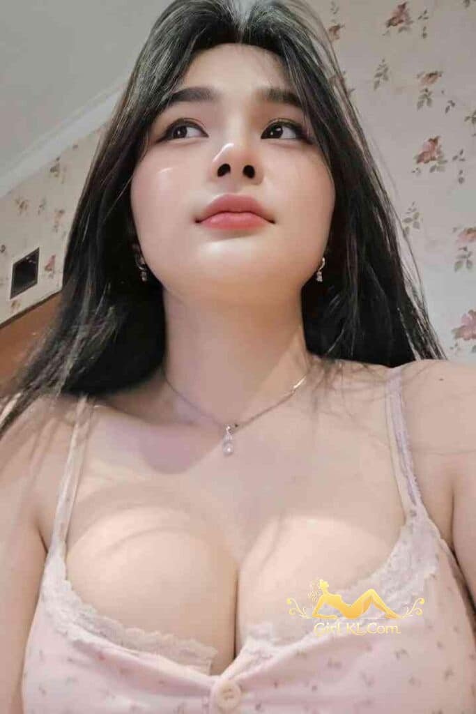 Beautiful Asian woman with long dark hair and a delicate necklace looking up.